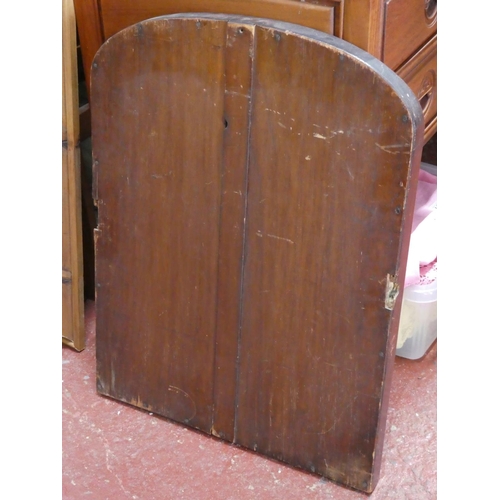 338 - An antique mahogany arched top mirror, measuring 57cm x 50cm.