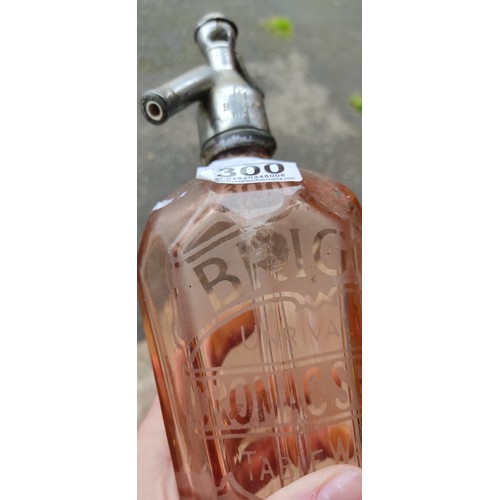 300 - An antique Briggs, Belfast coloured glass soda syphon.
