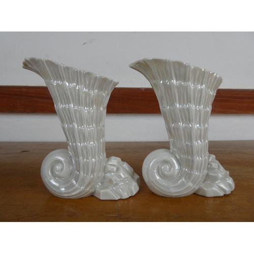 79 - A pair of decorative ceramic vases, measuring 14cm tall.