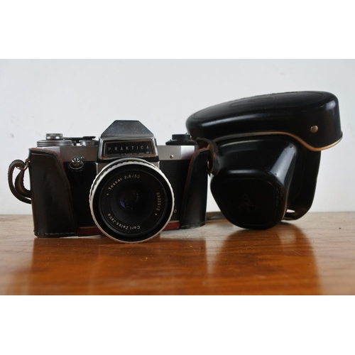 103 - A vintage leather cased Praktica camera and a vintage leather cased Zenit camera.