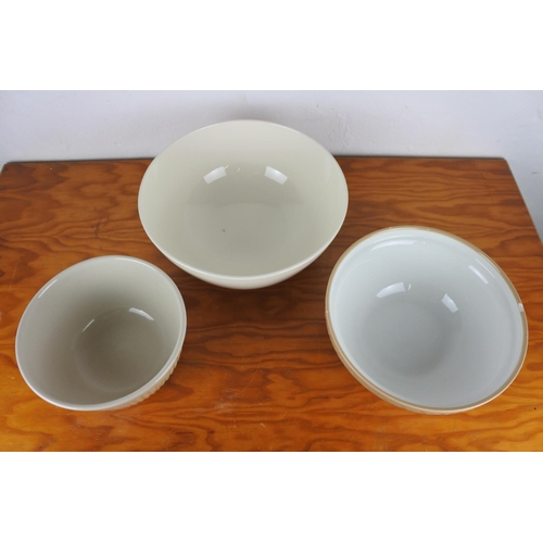 136 - A Mason Cash baking bowl (a/f), a Typhoon bowl and another.