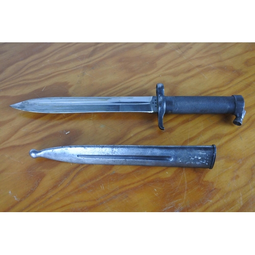 155 - A bayonet in scabbard, measuring 35cm long.