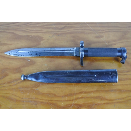 157 - A bayonet in scabbard, measuring 35cm long.