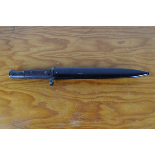 166 - A bayonet in scabbard, measuring 39cm long.