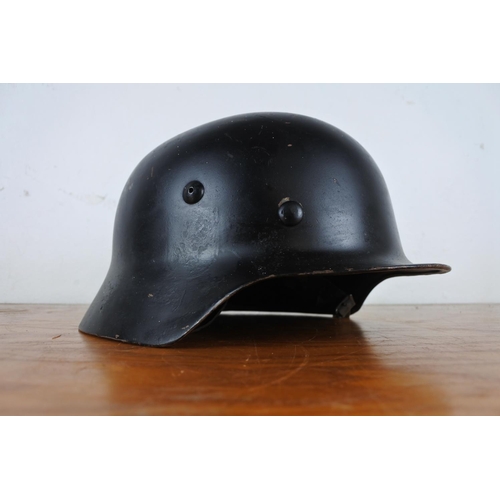 167 - A replica WW2 era German helmet with decal.