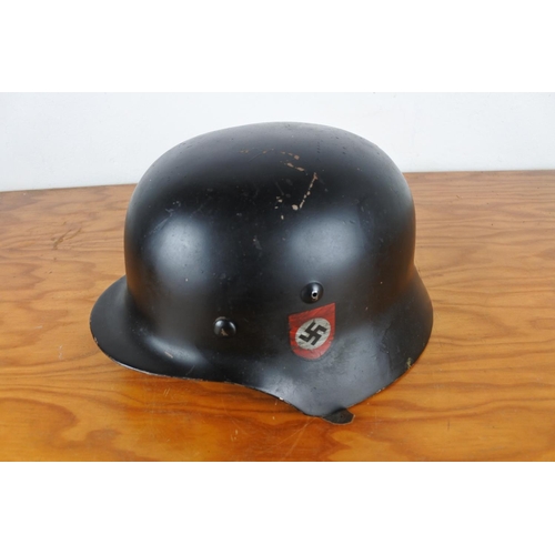 167 - A replica WW2 era German helmet with decal.