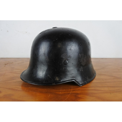 168 - A vintage German fire fighter helmet with liner.