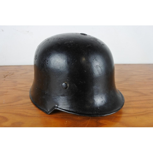 168 - A vintage German fire fighter helmet with liner.