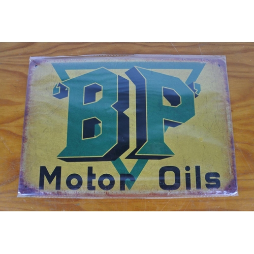 188 - A metal Lambretta sign and a BP Motor Oil sign.