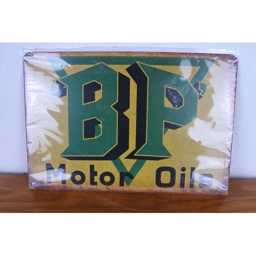 188 - A metal Lambretta sign and a BP Motor Oil sign.