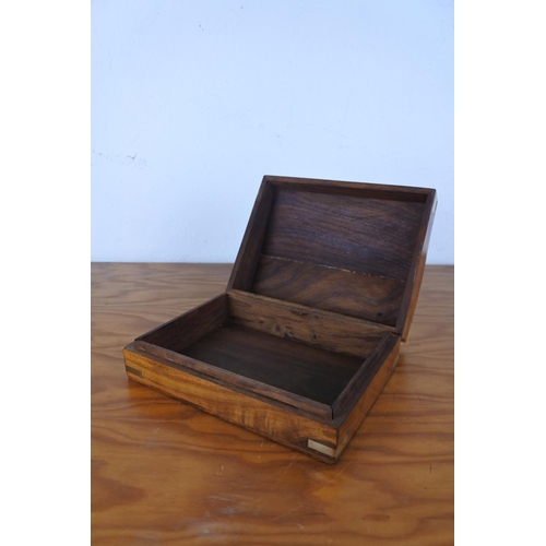 191 - A wooden and brass lidded box with anchor detail.