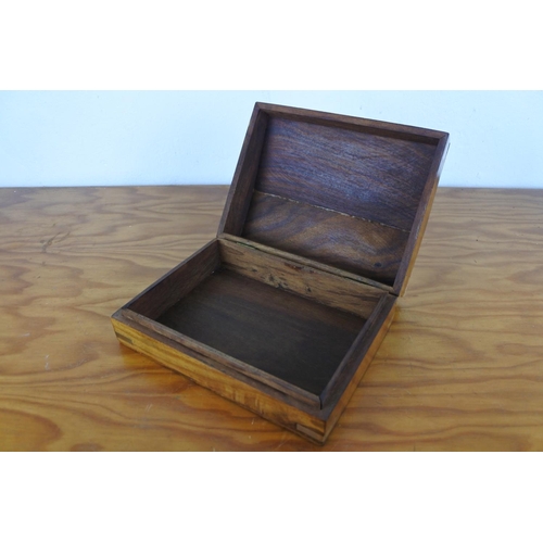 191 - A wooden and brass lidded box with anchor detail.