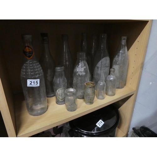 215 - A large assortment of antique/ vintage glass bottles.