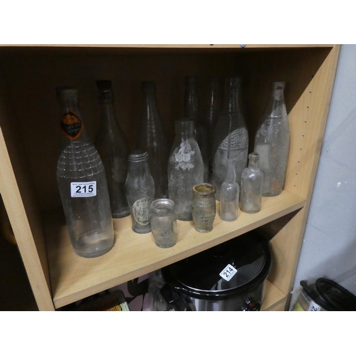 215 - A large assortment of antique/ vintage glass bottles.