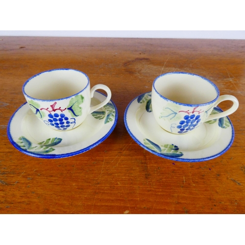 260 - A pair of Studio design Poole pottery tea cups and saucers.