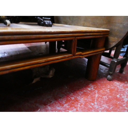 275 - A large oriental style coffee table, measuring 90 X 130cm X 45cm.