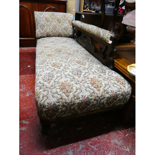 281 - An antique upholstered chaise lounge.