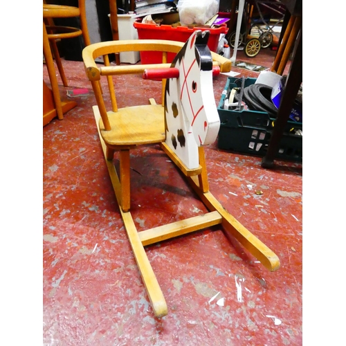 291 - A vintage wooden child's rocker.