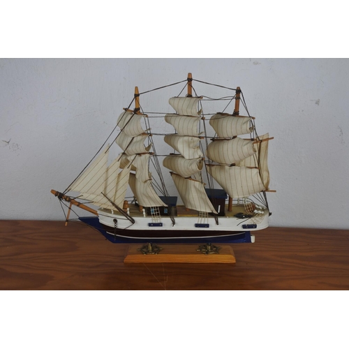 309 - A wooden ship on stand.