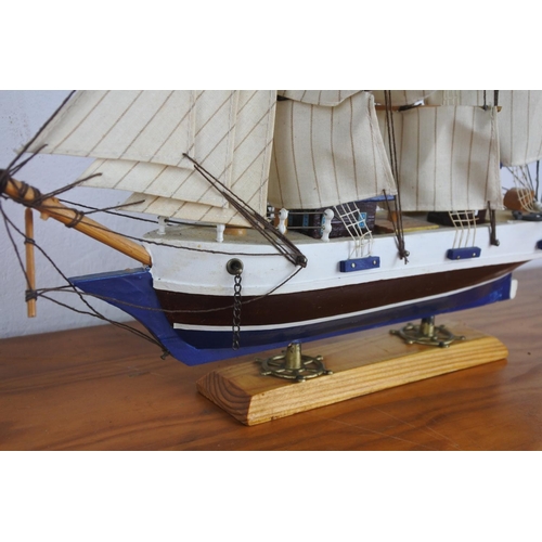 309 - A wooden ship on stand.