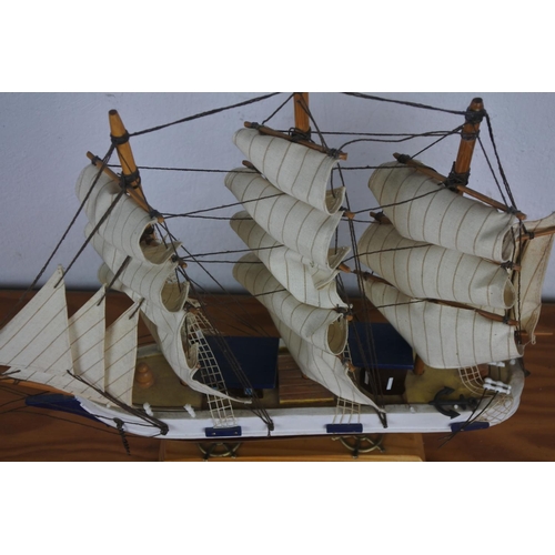 309 - A wooden ship on stand.