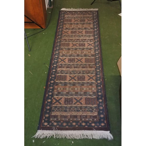 310 - A floor runner rug, measuring 240cm X 66cm.