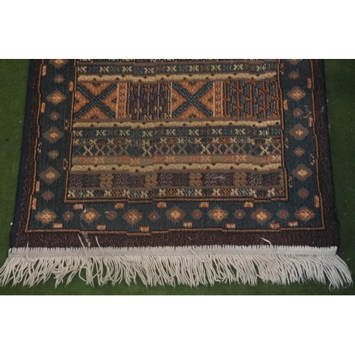 310 - A floor runner rug, measuring 240cm X 66cm.