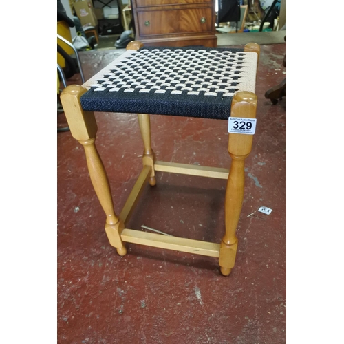 329 - A vintage rattan topped stool.