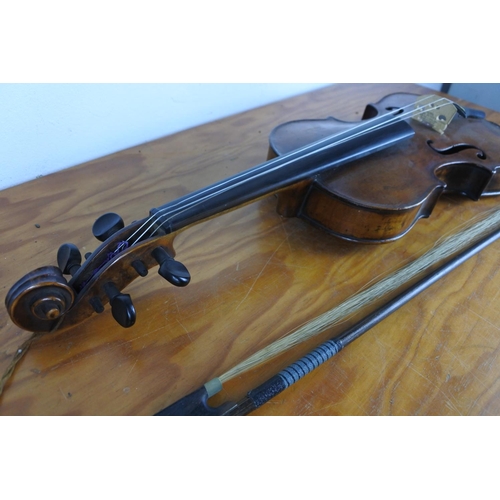 372 - An antique violin stamped to rear, 'Paganini' with bow.