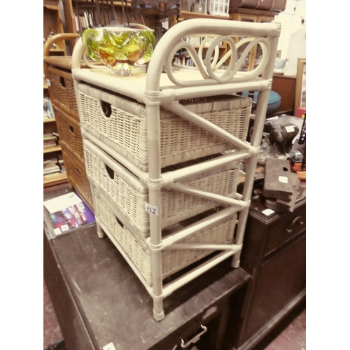 452 - A three drawer wicker storage cabinet.