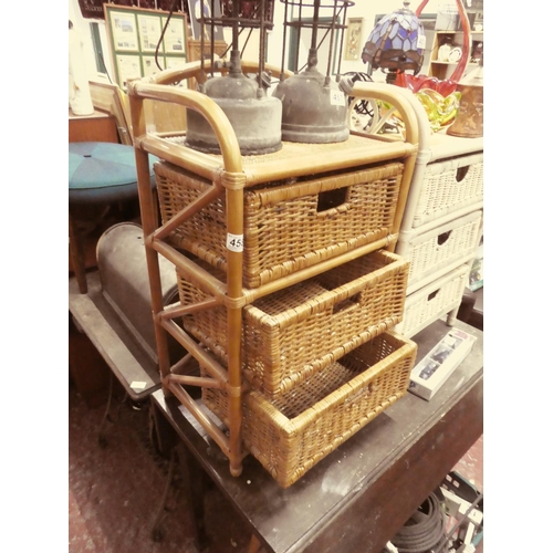 458 - A three drawer wicker cabinet.