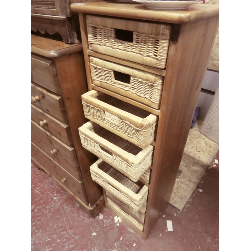 506 - A storage unit with 9 wicker basket drawers, measuring 127cm x 33cm x 39cm.