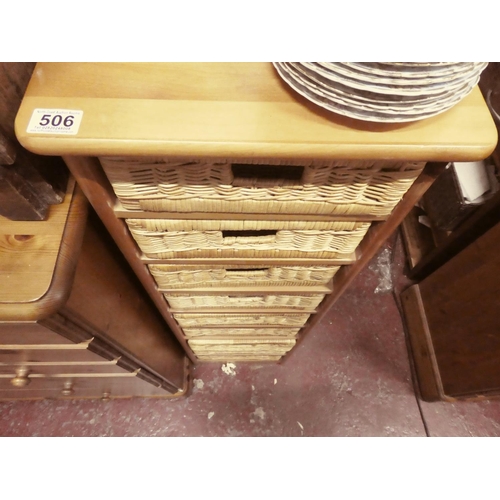 506 - A storage unit with 9 wicker basket drawers, measuring 127cm x 33cm x 39cm.