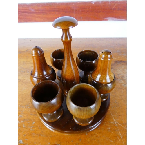 528 - A Mid Century egg cup and condiment set, along with a set of teak napkin rings.