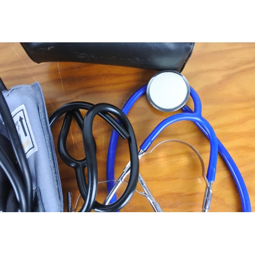 547 - A cased sphygmomanometer and a stethoscope.