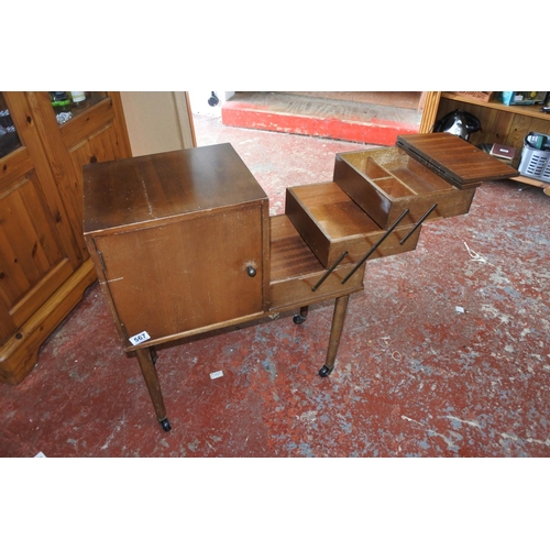 567 - A unusual vintage cabinet with cantilever sewing box.