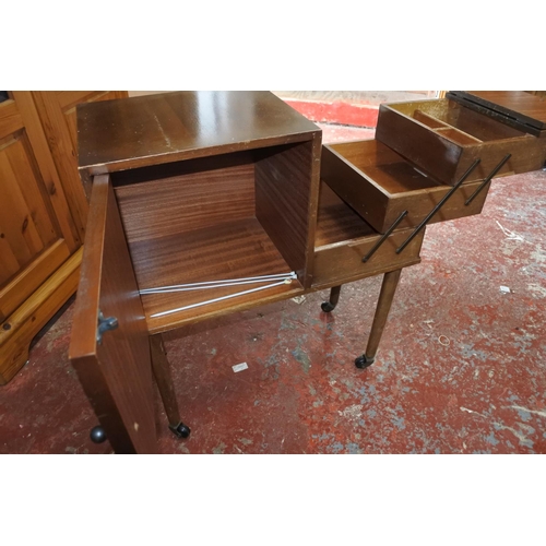 567 - A unusual vintage cabinet with cantilever sewing box.