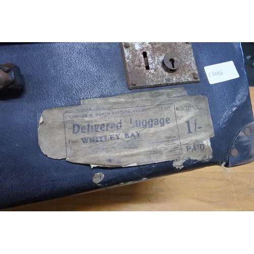 605 - A vintage leather suitcase.