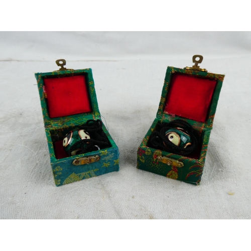 11 - Two boxed Oriental/ Chinese necklaces.