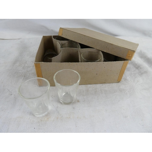 39 - A set of eleven vintage glass measures in original box.
