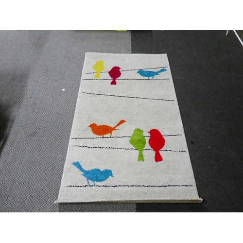 5 - A child's floor rug measuring 80cm x 150cm.
