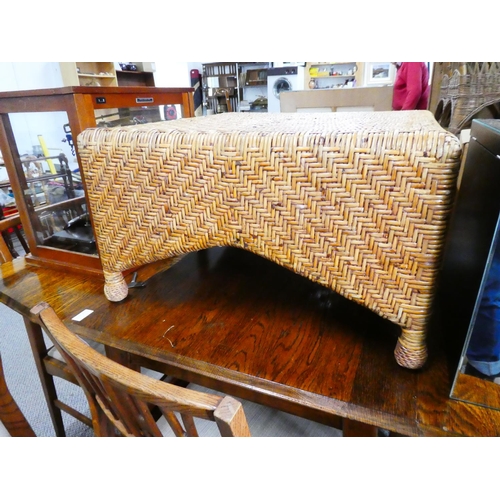 575 - A large wicker footstool.