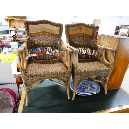 582 - A pair of decorative cane chairs.