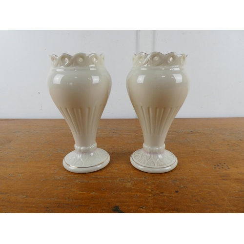 100 - A pair of Belleek pottery vases.