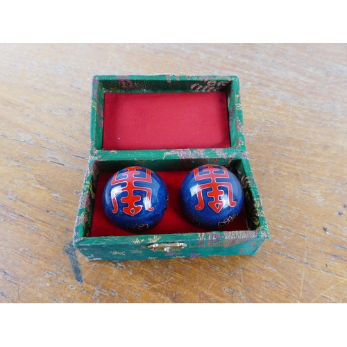 114 - A cased set of Chinese medicine balls.