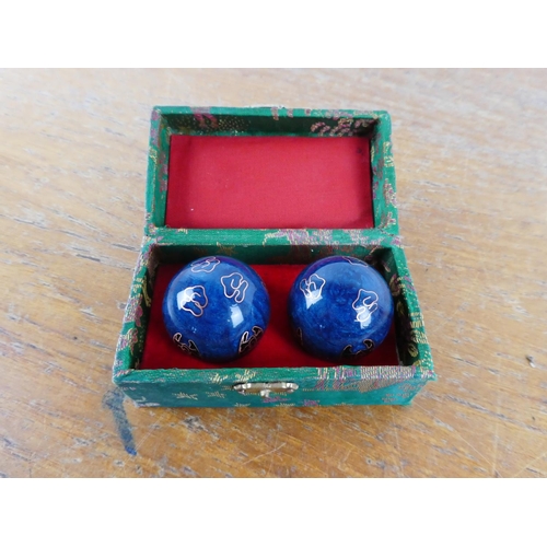 114 - A cased set of Chinese medicine balls.