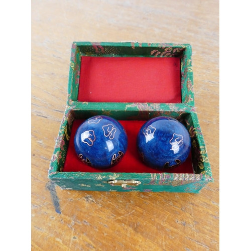 114 - A cased set of Chinese medicine balls.