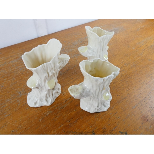 124 - A collection of three Belleek pottery 'Tree Stump' vases.