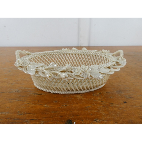 125 - A stunning Belleek pottery three strand basket with floral detail and presentation box.