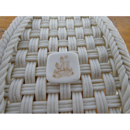 125 - A stunning Belleek pottery three strand basket with floral detail and presentation box.